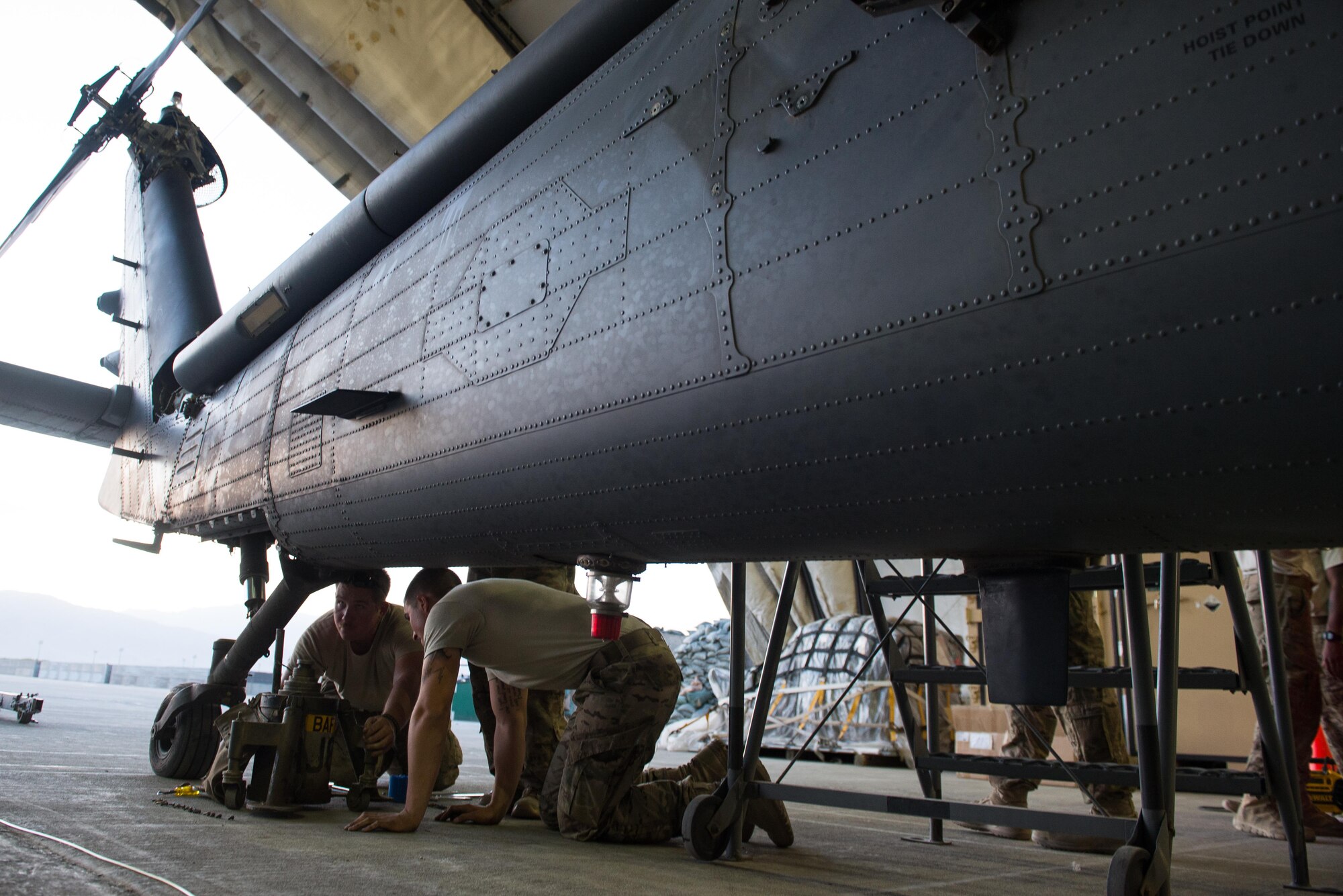 U.S. Air Force Senior Airman Joseph Roberts, left, and Airman 1st Class Trevor Krutsch, both 41st Expeditionary Helicopter Maintenance Unit crew chiefs, works to complete a 50 hour inspection on a HH-60 Pave Hawk helicopter at Bagram Airfield, Afghanistan, June 28, 2015. The 41st EHMU ensure Pave Hawks on Bagram are prepared for flight and return them to a mission-ready state once they land. (U.S. Air Force photo by Tech. Sgt. Joseph Swafford/Released)