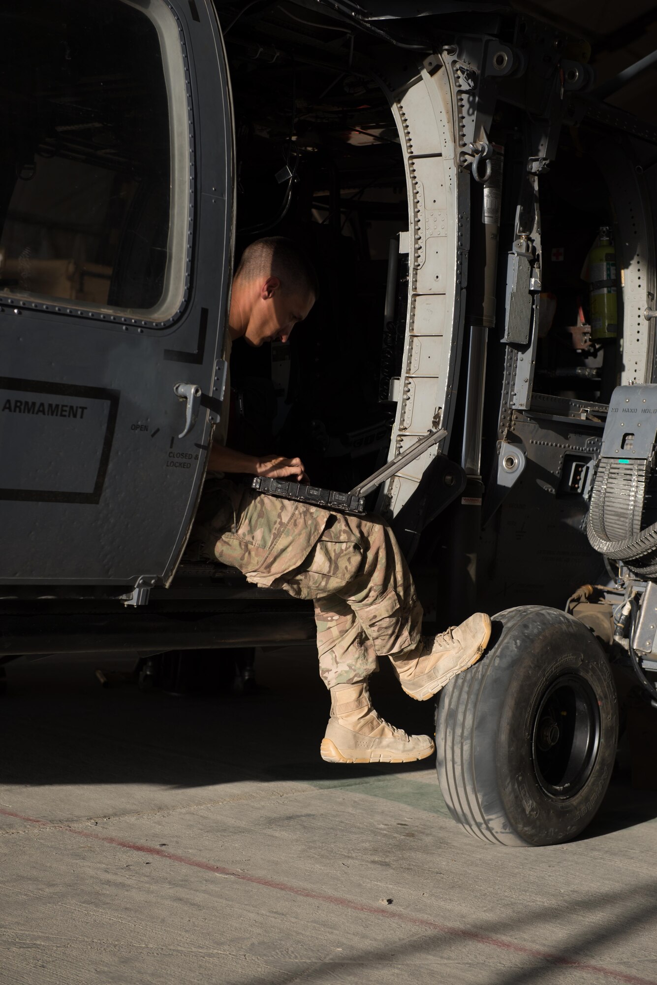U.S. Air Force Airman 1st Class Bronson Rutledge, 41st Expeditionary Helicopter Maintenance Unit HH-60 Pave Hawk helicopter hydraulics technician, completes a 50 hour inspection on a Pave Hawk at Bagram Airfield, Afghanistan, June 28, 2015. The 41st EHMU ensure Pave Hawks on Bagram are prepared for flight and return them to a mission-ready state once they land.  (U.S. Air Force photo by Tech. Sgt. Joseph Swafford/Released)