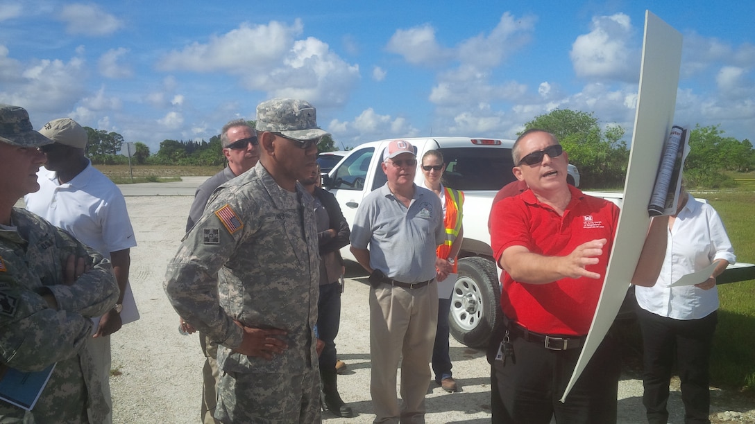 Orlando Ramos-Gines (right), project manager for the U.S. Army Corps of Engineers Jacksonville District, briefs the commander of the Corps' South Atlantic Division, Brig. Gen. David Turner, on construction progress at the C-44 Reservoir and Stormwater Treatment Area Project near Indiantown, Fla.  The briefing was part of a tour conducted June 23-24 where the general viewed ecosystem restoration and flood risk reduction projects in south Florida.