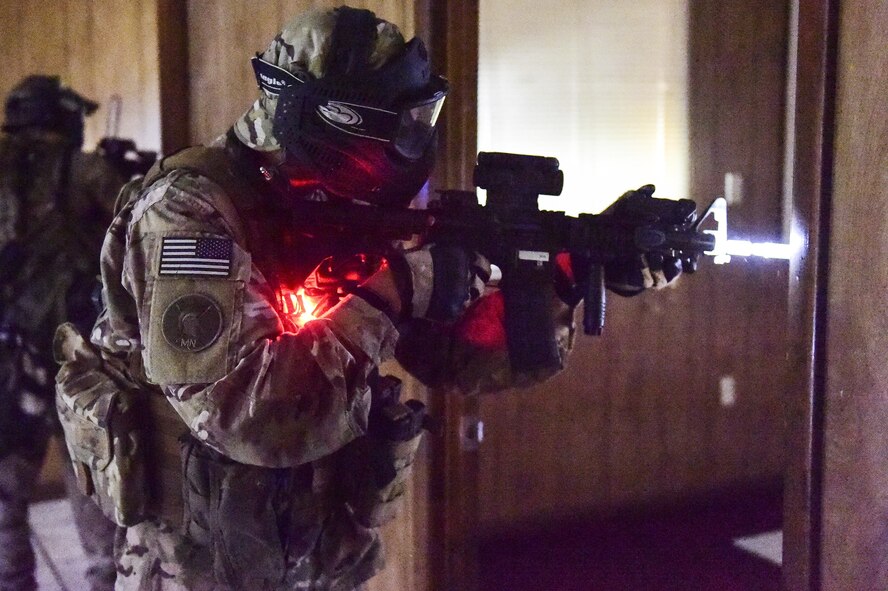 Airman 1st Class Ricardo Maggin, 1st Special Operations Security Forces Squadron Deployed Aircraft Ground Response Element, provides security after an altercation during a field training exercise in Fort Walton Beach, Fla., June 19, 2015. The FTX simulated the DAGRE team escorting a finance specialist to make a transfer of funds. (U.S. Air Force photo/Senior Airman Jeff Parkinson)