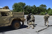 Deployed Aircraft Ground Response Element Airmen move their injured team member Airman 1st Class Joshua Belton, 1st Special Operations Security Forces Squadron DAGRE, to a safe location after a simulated injury during a field training exercise in Fort Walton Beach, Fla., June 19, 2015. The FTX simulated the DAGRE team escorting a finance specialist to make a transfer of funds. (U.S. Air Force photo/Senior Airman Jeff Parkinson) (U.S. Air Force photo/Senior Airman Jeff Parkinson)