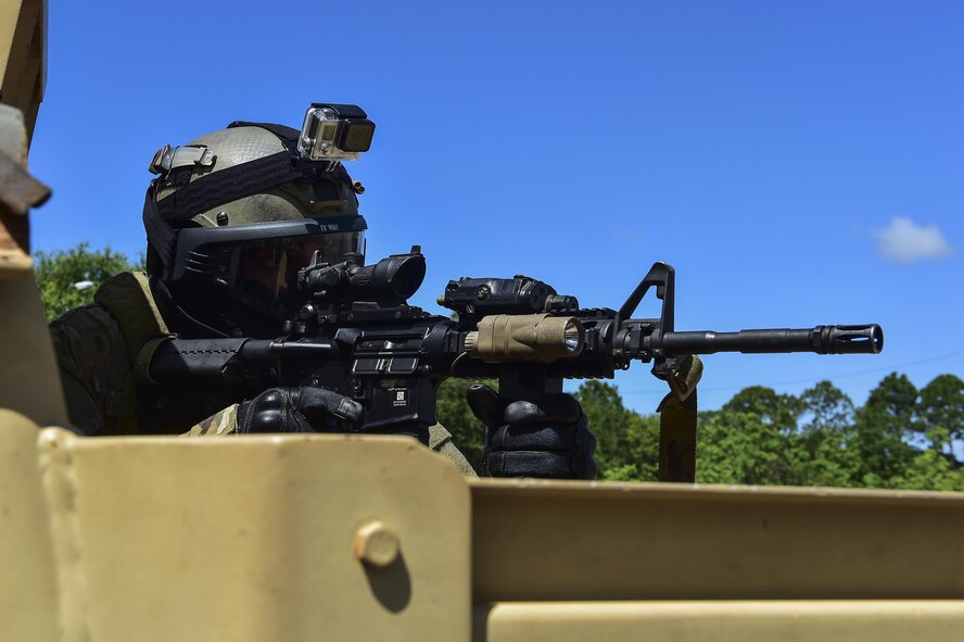 Staff Sgt. William Tibbetts, 1st Special Operations Comptroller Squadron NCO in-charge of relocation, provides security after a simulated enemy engagementduring a Deployed Aircraft Ground Response Element field training exercise in Fort Walton Beach, Fla., June 19, 2015. The FTX simulated the DAGRE team escorting a finance specialist to make a transfer of funds. (U.S. Air Force photo/Senior Airman Jeff Parkinson)