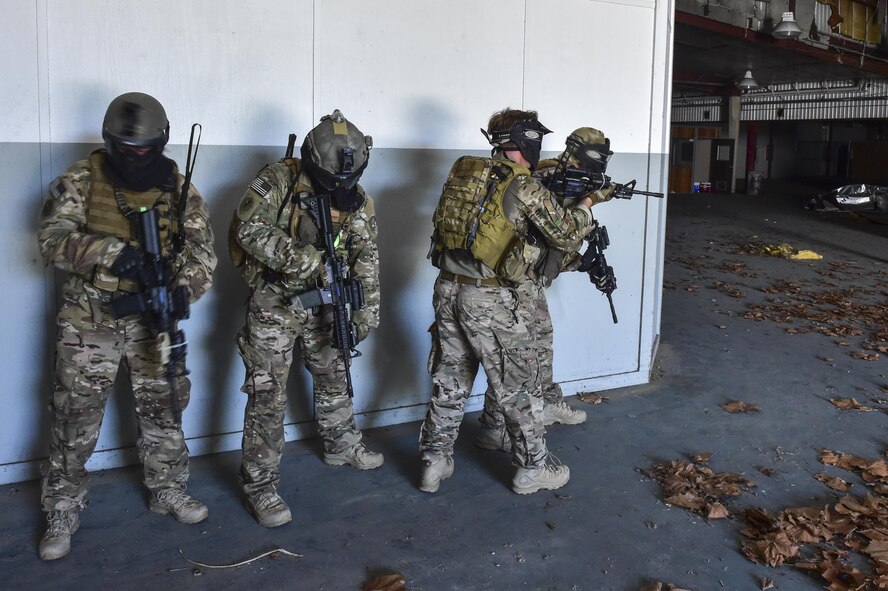 A Deployed Aircraft Ground Response Element team prepares to perform a simulated assault during close-quarters combat training in Fort Walton Beach, Fla., June 19, 2015. The FTX simulated the DAGRE team escorting a finance specialist to make a transfer of funds. (U.S. Air Force photo/Senior Airman Jeff Parkinson)