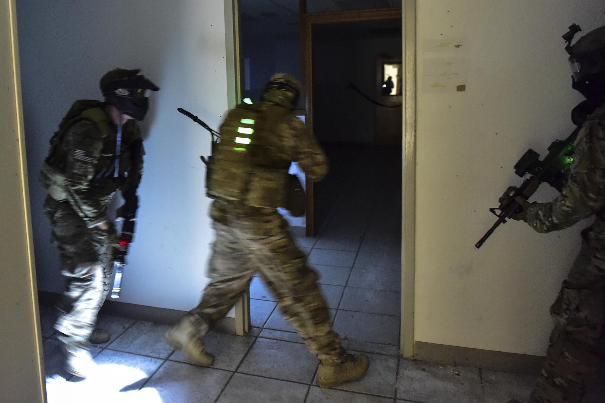 A Deployed Aircraft Ground Response Element team clears a room during close-quarters combat training in Fort Walton Beach, Fla., June 19, 2015. The FTX simulated the DAGRE team escorting a finance specialist to make a transfer of funds. (U.S. Air Force photo/Senior Airman Jeff Parkinson)