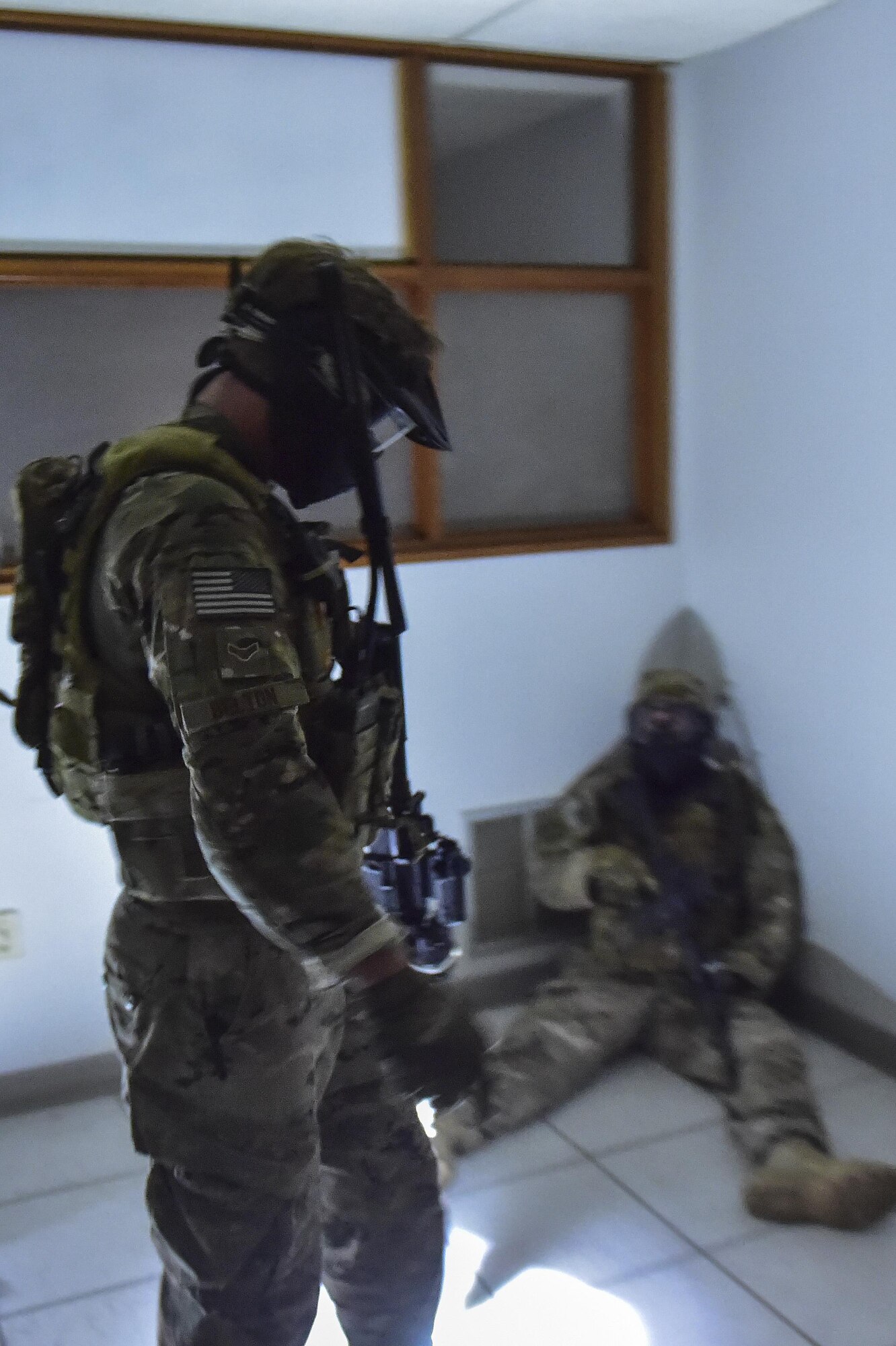 Airman 1st Class Joshua Belton, 1st Special Operations Security Forces Squadron Deployed Aircraft Ground Response Element, stands over a simulated enemy combatant after completing close-quarters combat training in Fort Walton Beach, Fla., June 19, 2015. The FTX simulated the DAGRE team escorting a finance specialist to make a transfer of funds. (U.S. Air Force photo/Senior Airman Jeff Parkinson)