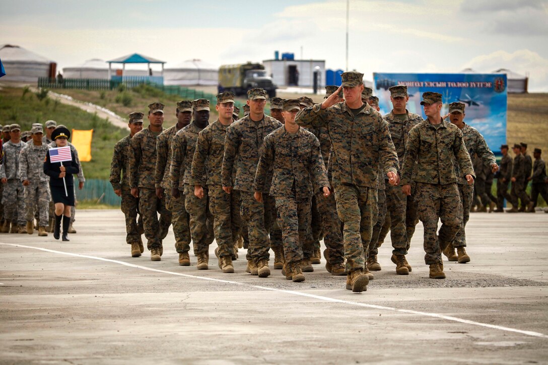 U.S. Marines pass in review during the closing ceremony of Khaan Quest 2015 at the Five Hills Training Area in Tavantolgoi, Mongolia, July 31, 2015. Khaan Quest is a regularly scheduled, multinational exercise hosted annually by Mongolian Armed Forces and co-sponsored by U.S. Army, Pacific, and U.S. Marine Corps Forces, Pacific. The U.S. Marines are with 3rd Battalion, 2nd Marine Regiment currently assigned to 4th Marine Regiment, 3rd Marine Division, III Marine Expeditionary Force under the unit deployment program. 