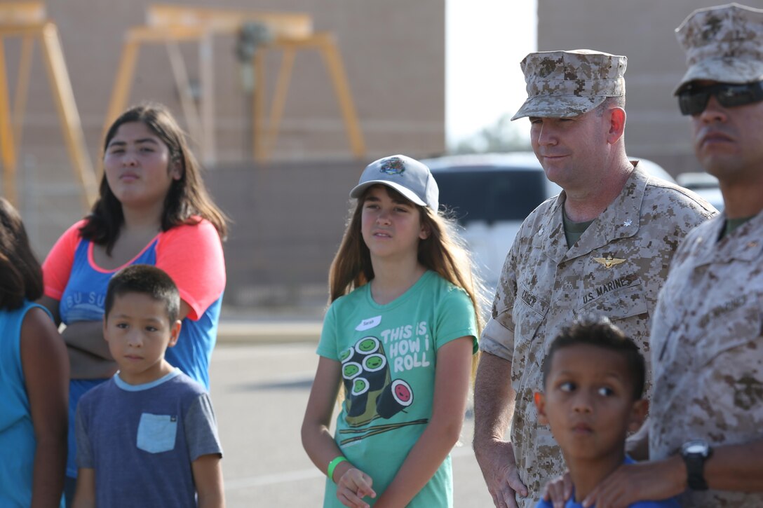 Marines and their family members watch a unit presentation during the Devil Dog Family Day aboard Marine Corps Air Station Miramar, California, June 26. The Devil Dog Family Day is an event for the family members of Marines to experience and learn what it’s like to be a Marine.
