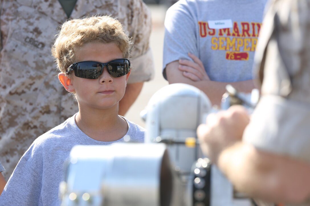 A boy watches as explosive ordnance disposal (EOD) technicians explain their equipment during Headquarters and Headquarters Squadron’s Devil Dog Family Day aboard Marine Corps Air Station Miramar, California, June 26. The Devil Dog Day gave Marines a chance to show their families a glimpse of day-to-day life in the Marine Corps.