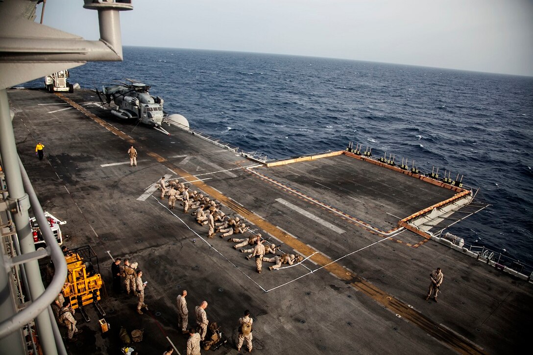 GULF OF ADEN (June 29, 2015) U.S. Marines with India Battery, Battalion Landing Team 3rd Battalion, 1st Marine Regiment, 15th Marine Expeditionary Unit, fire their weapons to establish a battlesight zero with their iron sights on the flight deck of the Wasp-class amphibious assault ship USS Essex (LHD 2). Establishing a BZO ensures the weapon is consistent, allowing the Marines to use the fundamentals of marksmanship to engage their targets.  The 15th MEU is embarked on the Essex Amphibious Ready Group and deployed to maintain regional security in the U.S. 5th Fleet area of operations. (U.S. Marine Corps photo by Cpl. Elize McKelvey/Released)