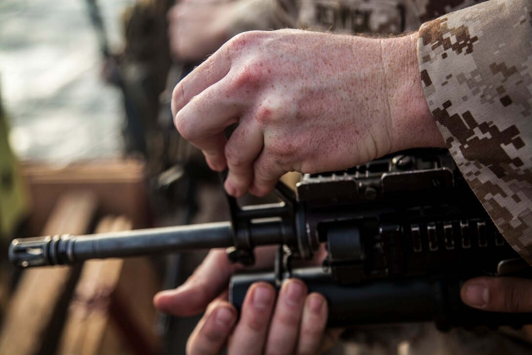 GULF OF ADEN (June 29, 2015) A U.S. Marine with India Battery, Battalion Landing Team 3rd Battalion, 1st Marine Regiment, 15th Marine Expeditionary Unit, adjusts his iron sights to establish a battlesight zero for his weapon on the flight deck of the Wasp-class amphibious assault ship USS Essex (LHD 2). Establishing a BZO ensures the weapon is consistent, allowing the Marines to use the fundamentals of marksmanship to engage their targets. The 15th MEU is embarked on the Essex Amphibious Ready Group and deployed to maintain regional security in the U.S. 5th Fleet area of operations. (U.S. Marine Corps photo by Cpl. Elize McKelvey/Released)