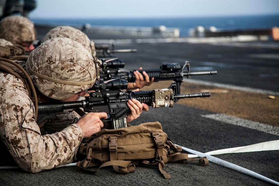 GULF OF ADEN (June 29, 2015) U.S. Marines with India Battery, Battalion Landing Team 3rd Battalion, 1st Marine Regiment, 15th Marine Expeditionary Unit, fire their weapons to establish a battlesight zero on the flight deck of the Wasp-class amphibious assault ship USS Essex (LHD 2). Establishing a BZO ensures the weapon is consistent, allowing the Marines to use the fundamentals of marksmanship to engage their targets. The 15th MEU is embarked on the Essex Amphibious Ready Group and deployed to maintain regional security in the U.S. 5th Fleet area of operations. (U.S. Marine Corps photo by Cpl. Elize McKelvey/Released)