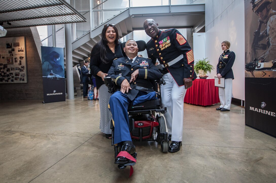 Sgt. Maj. of the Marine Corps Ronald L. Green poses for a photograph with guests of a sunset parade reception held at the Women in Military Service for America Memorial, Arlington, Va., June 30, 2015. (U.S. Marine Corps photo by Sgt. Melissa Marnell/Released)