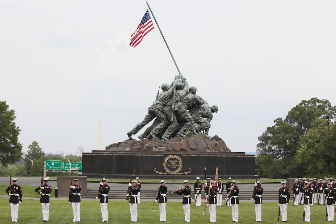 The U.S. Marine Corps Silent Drill Platoon preforms during a sunset parade at the Marine Corps War Memorial, Arlington, Va., June 30, 2015. The Honorable Mr. Ashton B. Carter, Secretary of Defense, was the guest of honor for the parade, and Gen. Joseph F. Dunford Jr., commandant of the U.S. Marine Corps, was the hosting official. Since September 1956, marching and musical units from Marine Barracks Washington, D.C., have been paying tribute to those whose“uncommon valor was a common virtue” by presenting sunset parades in the shadow of the 32-foot high figures of the United States Marine Corps War Memorial. (U.S. Marine Corps photo by Lance Cpl. Alejandro Sierras/Released)
