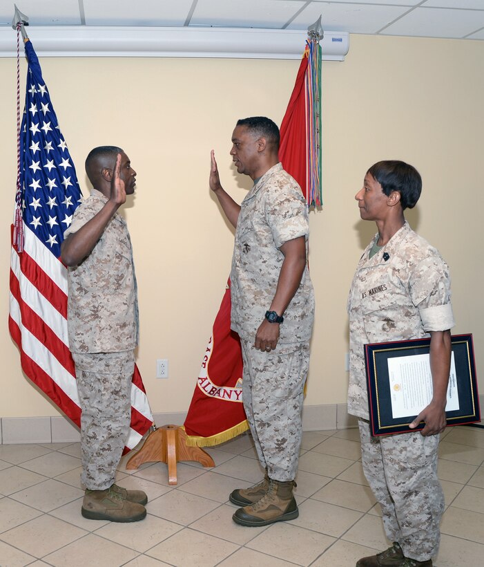 Col. James C. Carroll III, commanding officer, Marine Corps Logistics Base Albany, (left) recites the oath of office administered by Maj. Gen. Craig C. Crenshaw, commanding general, Marine Corps Logistics Command, as Sgt. Maj. Stephanie K. Murphy, sergeant major, LOGCOM, looks on during his promotion ceremony, July 1, at LOGCOM.