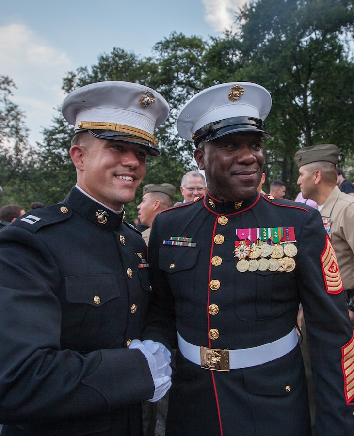 Sgt. Maj. of the Marine Corps Ronald L. Green poses for a photo with a guest following the conclusion of a Sunset Parade at the Marine Corps War Memorial, Arlington, Va., June 30, 2015. (U.S. Marine Corps photo by Sgt. Melissa Marnell/Released)