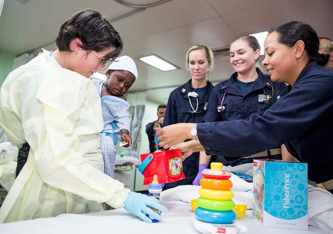 ARAWA, Autonomous Region Of Bougainsville, Papua New Guinea (June 30, 2015) - Medical personnel calm an infant in the casualty reception area of hospital ship USNS Mercy (T-AH 19) after a recovery effort. An MH-60S Seahawk helicopter from Helicopter Combat Squadron 21 picked up six passengers including the infant and returned from Han Island to the ship during the second port mission of Pacific Partnership 2015 in Papua New Guinea. Pacific Partnership is in its tenth iteration and is the largest annual multilateral humanitarian assistance and disaster relief preparedness mission conducted in the Indo-Asia-Pacific region. While training for crisis conditions, Pacific Partnership missions to date have provided real world medical care to approximately 270,000 patients and veterinary services to more than 38,000 animals. Additionally, the mission has provided critical infrastructure development to host nations through more than 180 engineering projects. 150630-M-DN141-634   