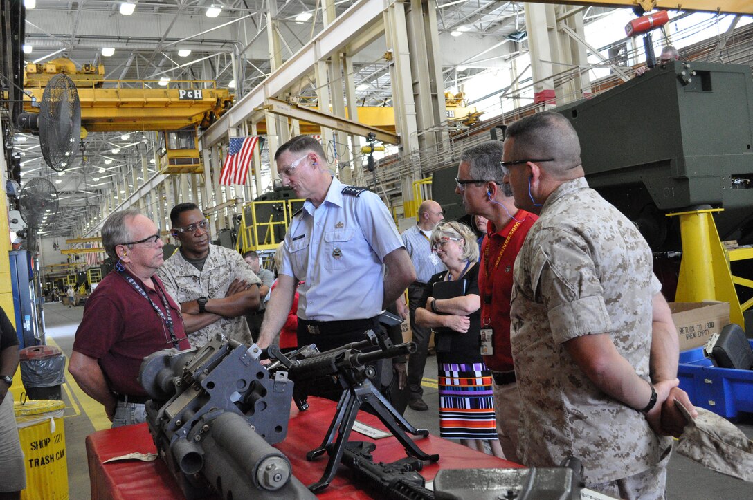 Sidney Sutherland, small arms repairer, Marine Depot Maintenance Command/Production Plant Albany, briefs Air Force Lt. Gen. Andrew Busch, director, Defense Logistics Agency, Fort Belvoir, Va., on the weapons repaired within the PPA Small Arms shop during Busch's tour of the production plant, July 1.