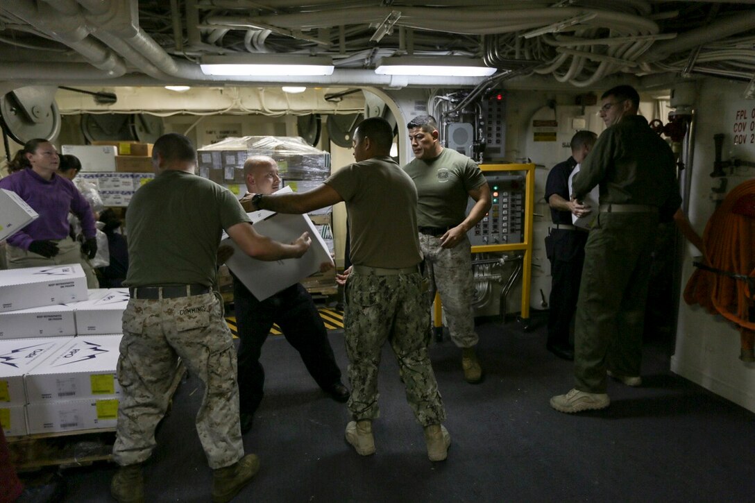 U.S. Marines and Sailors conduct a resupply at sea aboard USS Anchorage (LPD 23) . Anchorage is part of the Essex Amphibious Ready Group and, with the embarked 15th Marine Expeditionary Unit, is deployed in support of maritime security operations and theater security cooperation efforts in the U.S. 5th Fleet area of operations. (U.S. Marine Corps photo by Sgt. Jamean Berry/Released)