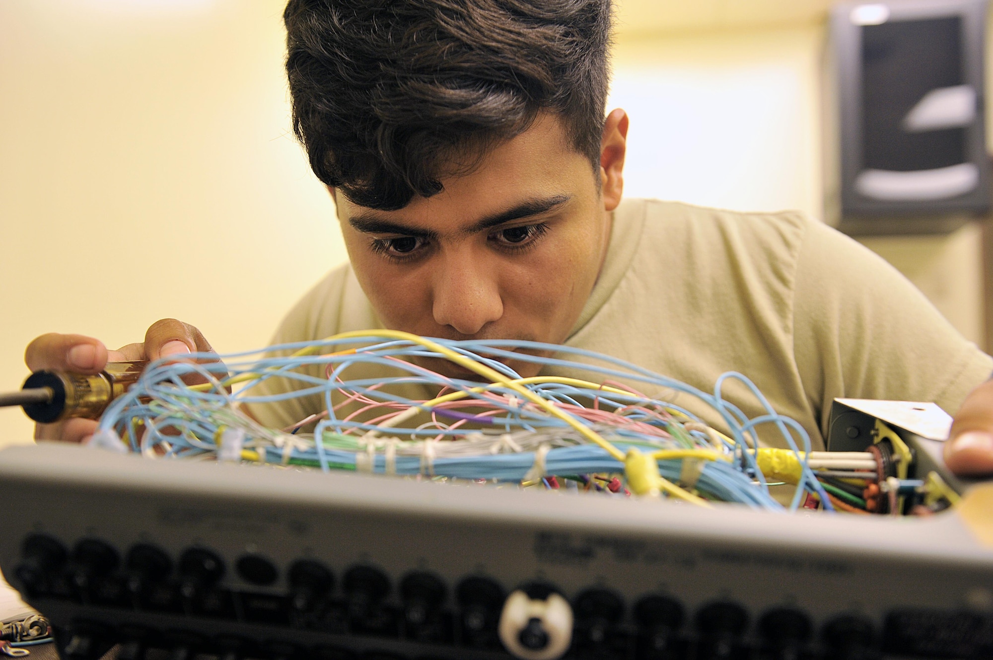 U.S. Air Force Airman 1st Class Victor Lopez Juarez, 18th Component Maintenance Squadron electrical and environmental journeyman, reviews inside of an F-15C Eagle essential bus circuit breaker panel on Kadena Air Base, Japan, June 29, 2015. Airmen from 18th CMS have been working around-the-clock to rewire F-15C Eagle essential bus circuit breaker panels to help increase mission capabilities and to ensure unmatched combat power of Kadena's aircraft. (U.S. Air Force photo by Naoto Anazawa/Released)