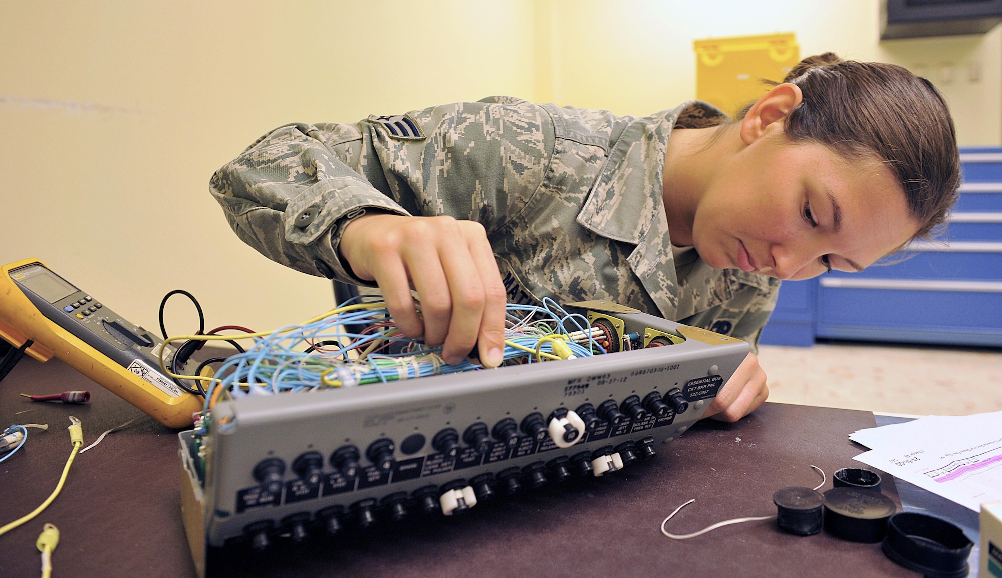 U.S. Air Force Senior Airman Erin Matheny, 18th Component Maintenance Squadron electrical and environmental journeyman, checks for applying power of an F-15C Eagle essential bus circuit breaker panel on Kadena Air Base, Japan, June 29, 2015. Airmen from 18th CMS have been working around-the-clock to rewire F-15C Eagle essential bus circuit breaker panels to help increase mission capabilities and to ensure unmatched combat power of Kadena's aircraft. (U.S. Air Force photo by Naoto Anazawa/Released)