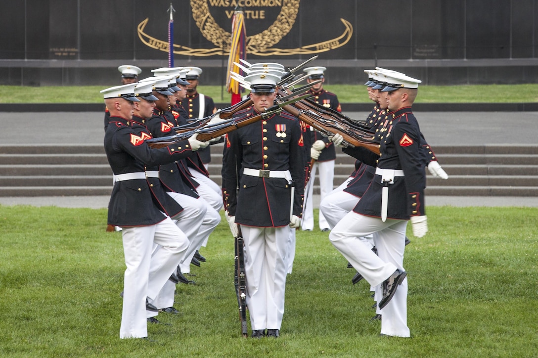 The U.S. Marine Corps Silent Drill Platoon preforms during the sunset parade at the Marine Corps War Memorial, Arlington, Va., June 30, 2015. The Honorable Mr. Ashton B. Carter, Secretary of Defense, was the guest of honor for the parade, and Gen. Joseph F. Dunford Jr., commandant of the U.S. Marine Corps, was the hosting official. Since September 1956, marching and musical units from Marine Barracks Washington, D.C., have been paying tribute to those whose “uncommon valor was a common virtue” by presenting sunset parades in the shadow of the 32-foot high figures of the United States Marine Corps War Memorial.