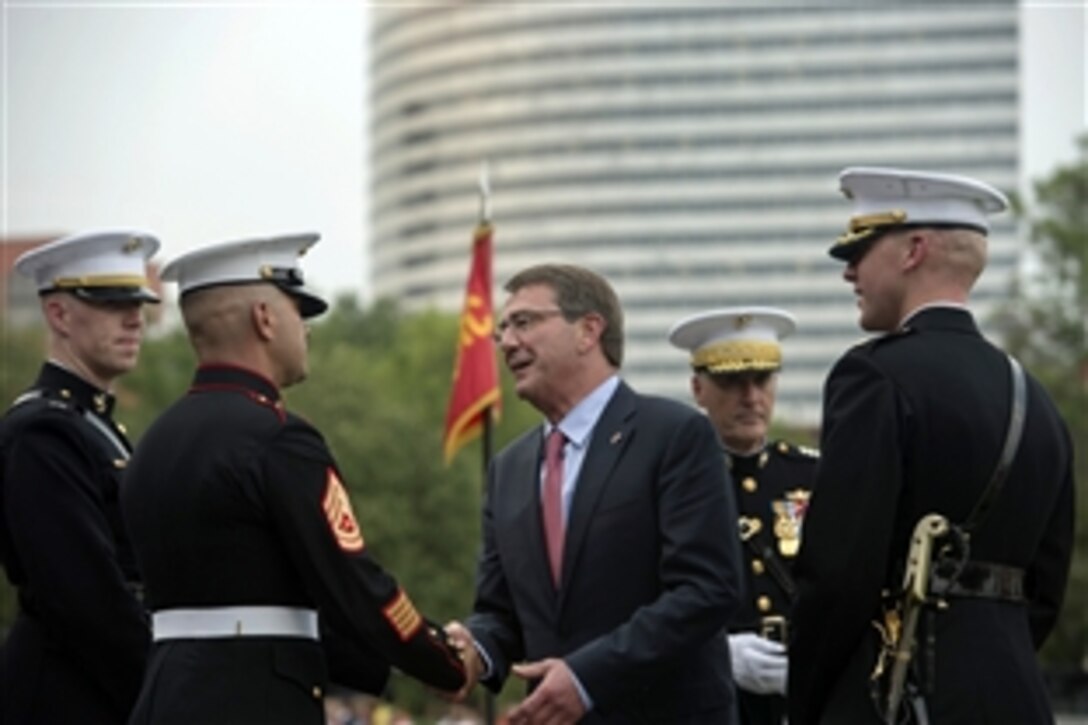 Defense Secretary Ash Carter thanks Marines following the Sunset Parade at the U.S. Marine Corps War Memorial in Arlington, Va., where he was the guest of honor, June 30, 2015.