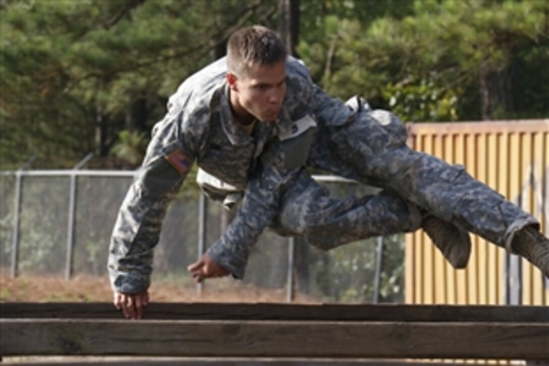 Army Pfc. Nick Day vaults over a beam at an obstacle course during the last leg of long range surveillance selection on Fort Bragg, N.C., June 24, 2015. On the final day of selection, candidates also completed a 20-kilometer ruck march and a written exam. Day is an infantryman assigned to the 82nd Airborne Division's Company C, 1st Battalion, 325th Airborne Infantry Regiment, 2nd Brigade Combat Team.

