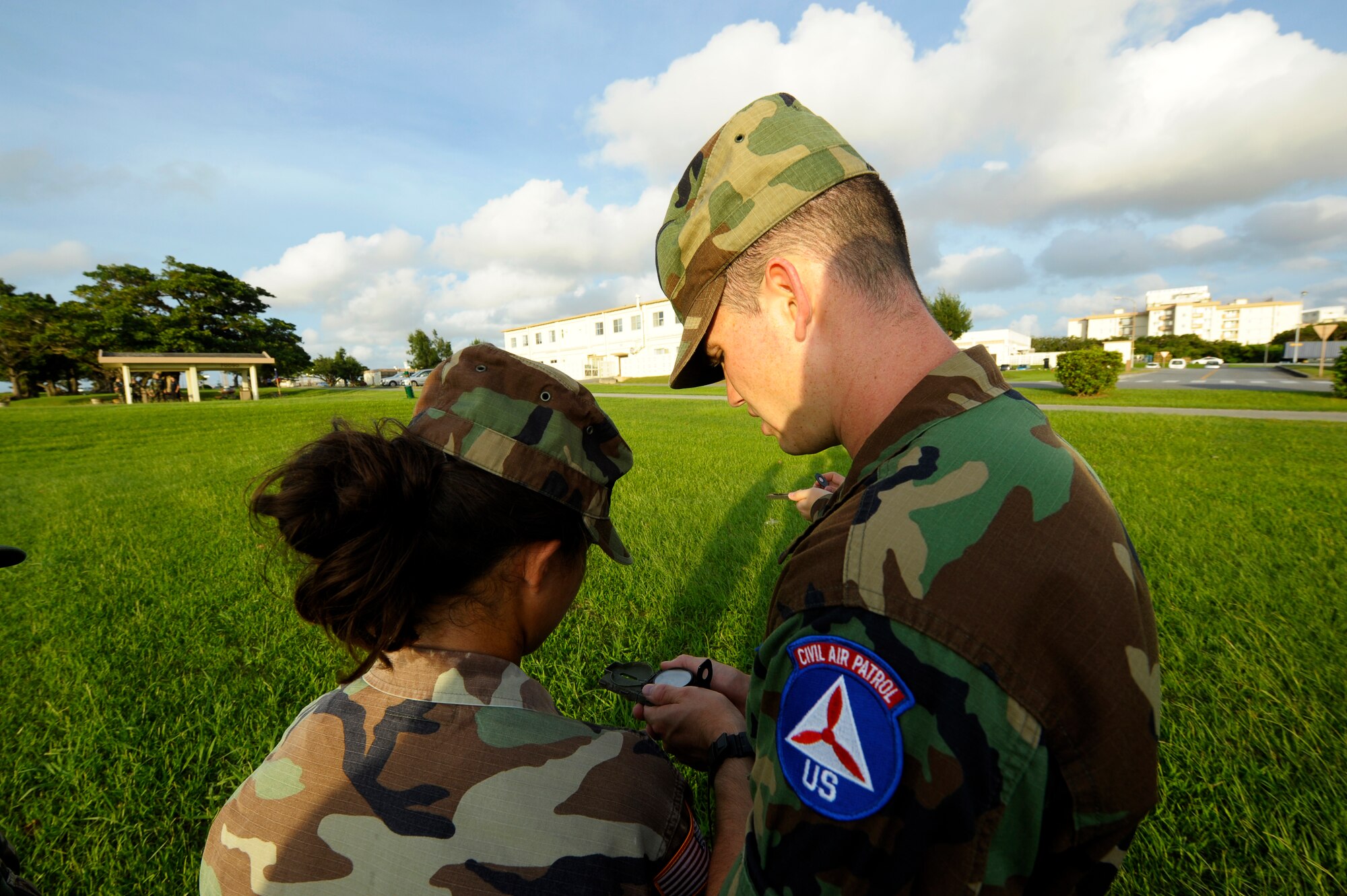 U.S. Air Force Senior Airman Chance Sheek, 18th Logistics Readiness Squadron vehicle operator, teaches a young cadet in the Civil Air Patrol how to use a compass on Kadena Air Base, Japan, June 26, 2015. Sheek is now a first lieutenant in the Civil Air Patrol and is held responsible for ground emergency training such as search and rescues. (U.S. Air Force photo by Airman 1st Class Zackary A. Henry)