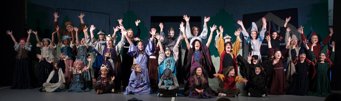 Children from the F.E. Warren Air Force Base, Wyo., community sing the finale of the play “King Arthur’s Quest” during their curtain call June 26, 2015. The 31 young actors trained for the debut of the play for four and a half days. (U.S. Air Force photo by Airman 1st Class Malcolm Mayfield)