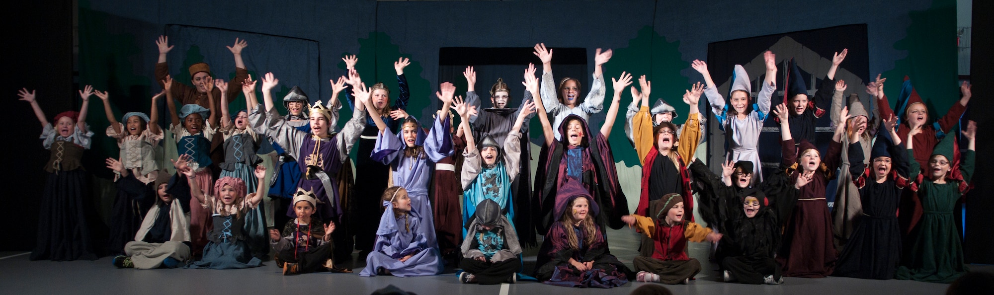 Children from the F.E. Warren Air Force Base, Wyo., community sing the finale of the play “King Arthur’s Quest” during their curtain call June 26, 2015. The 31 young actors trained for the debut of the play for four and a half days. (U.S. Air Force photo by Airman 1st Class Malcolm Mayfield)