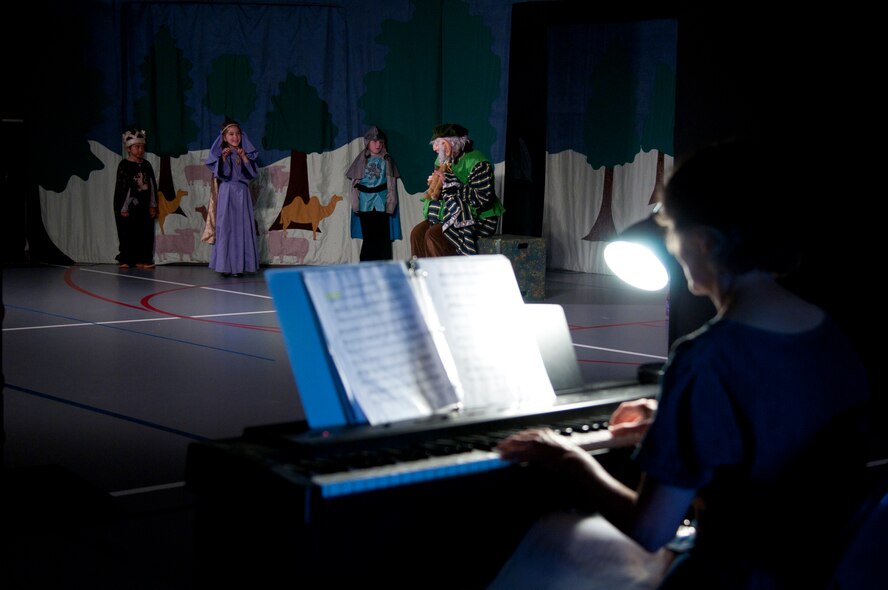 Shirley Falk plays the piano June 26, 2015, for the play “King Arthur’s Quest” in the Youth Center on F.E. Warren Air Force Base, Wyo. The play was performed by children from the Warren community, who were taught by Jessica Foley and Kristen Krak, Missoula Children’s Theatre Tour actor and directors. (U.S. Air Force photo by Airman 1st Class Malcolm Mayfield)