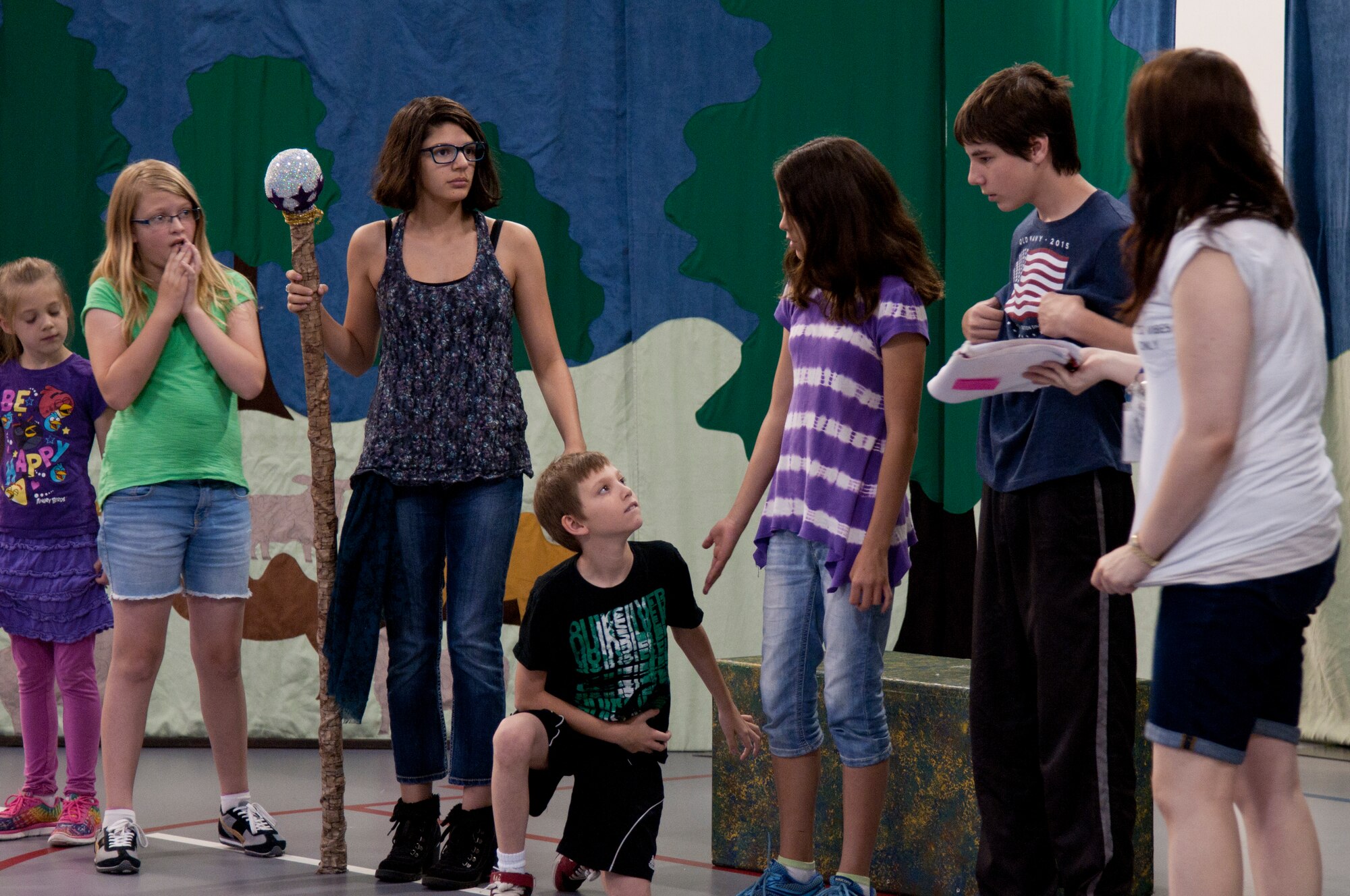 Children and teens practice their lines June 25, 2015, for the play they performed the next day, “King Arthur’s Quest.” The young actors had just received their props for the first time. (U.S. Air Force photo by Airman 1st Class Malcolm Mayfield)
