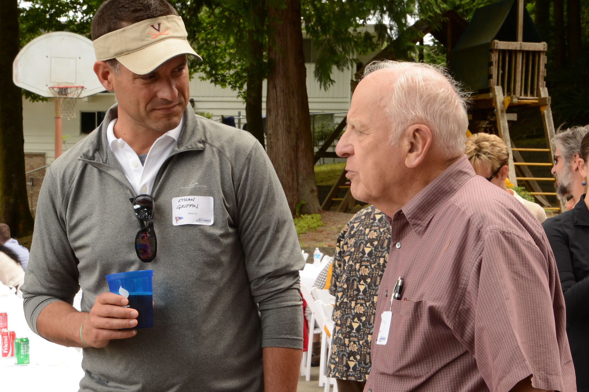 Col. Ethan Griffin (left), 62nd Airlift Wing vice commander, talks with retired Maj. Gen.  Donald Brown, former 62nd Airlift Wing commander, during the 2015 Evergreen Fleet Cruise,  June 24, 2015 at the Wollochet Bay Outstation, Gig Harbor, Wash. The Evergreen Fleet Cruise begins with a breakfast reception at the Tacoma Yacht Club, followed by a cruise to Wollochet Bay Outstation in the Puget Sound for a picnic lunch, and finally a cruise back to the Tacoma Yacht Club. (U.S. Air Force photo\Staff Sgt. Katie Jackson)