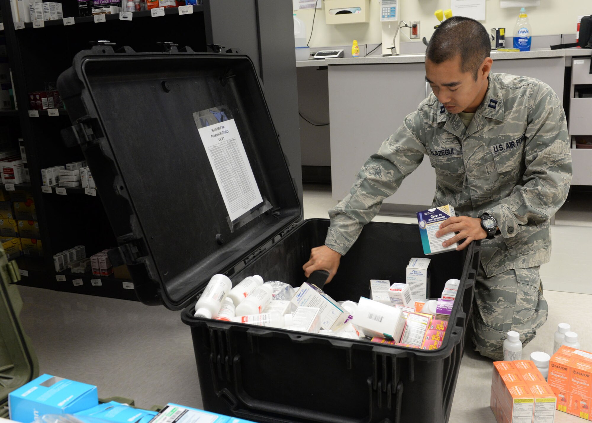 Capt. Ronald Elazegui, 36th Medical Support Squadron pharmacist, organizes a medical evacuation kit July 1, 2015, at Andersen Air Force Base, Guam. The kit is composed of medical essentials used in emergencies where the clinic is evacuated. (U.S. Air Force photo by Airman 1st Class Joshua Smoot/Released)