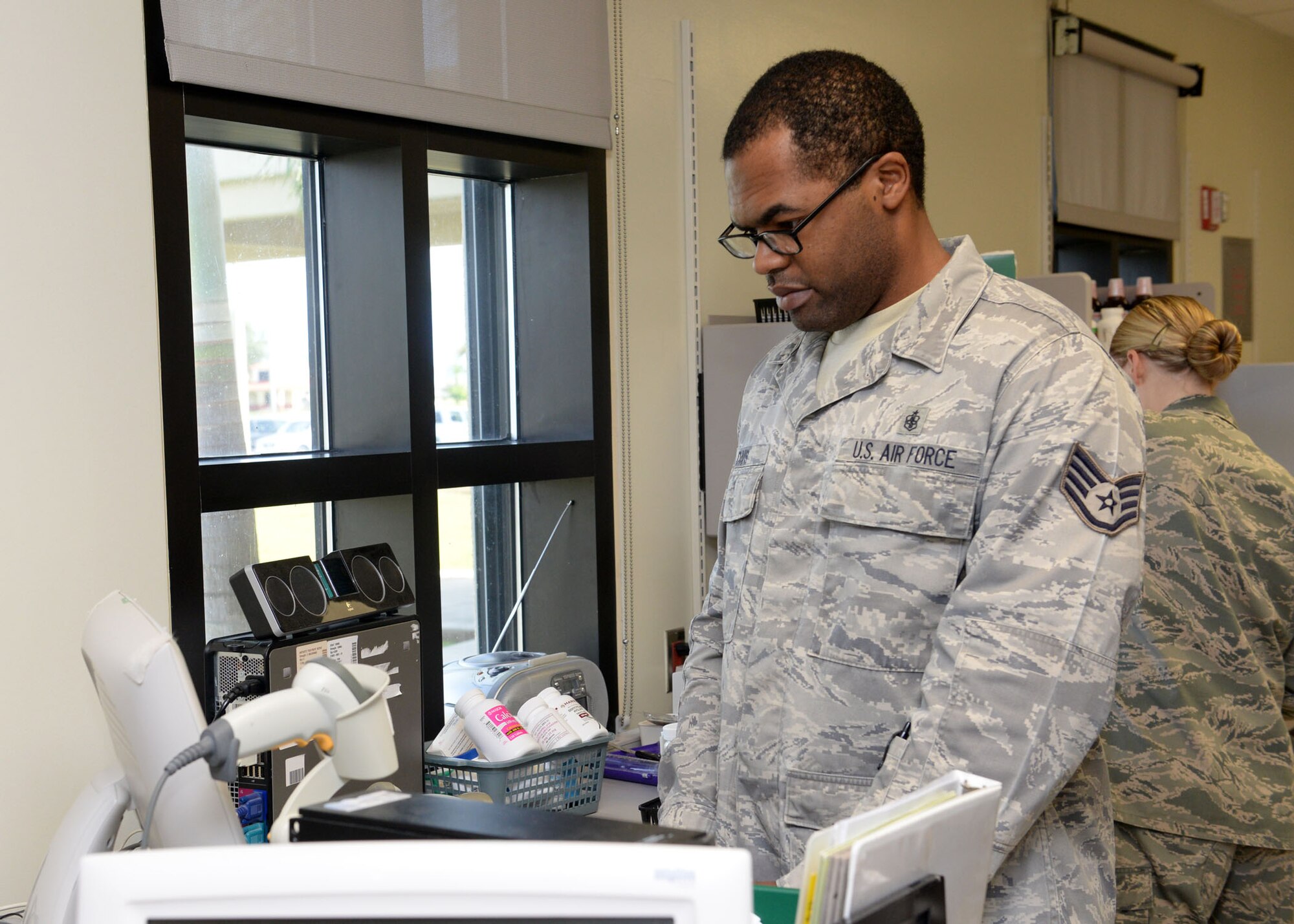 Staff Sgt. Jeremy Davis, 36th Medical Support Squadron pharmacy technician, prints out prescriptions for patients July 1, 2015, at Andersen Air Force Base, Guam. The unit consists of three pharmacy technicians and two pharmacists working in unison to ensure Team Andersen members receive the proper medications. (U.S. Air Force photo by Airman 1st Class Joshua Smoot/Released)