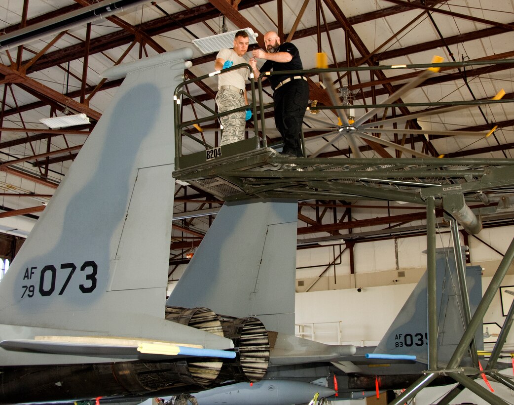 Jeremy Hannigan, 362nd Training Squadron instructor, teaches Airman 1st Class Brandon Barrett, 362nd Training Squadron student, how to install and remove the left vertical stabilizer on an F-15 Eagle Jun. 30, 2015, at Sheppard Air Force Base, Texas. The F-15 aircraft maintenance apprentice course instructs students on how to properly maintain mission capabilities. (U.S. Air Force photo by Danny Webb/Released)  