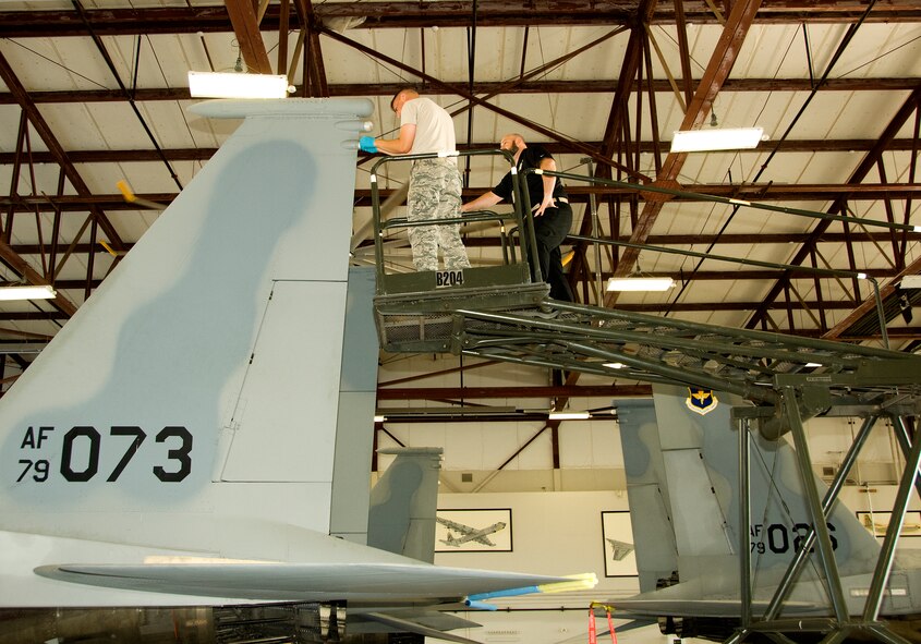 Jeremy Hannigan, 362nd Training Squadron instructor, teaches Airman 1st Class Brandon Barrett, 362nd Training Squadron student, how to install and remove the left vertical stabilizer on an F-15 Eagle Jun. 30, 2015, at Sheppard Air Force Base, Texas. The F-15 aircraft maintenance apprentice course instructs students on how to properly maintain mission capabilities. (U.S. Air Force photo by Danny Webb/Released)  