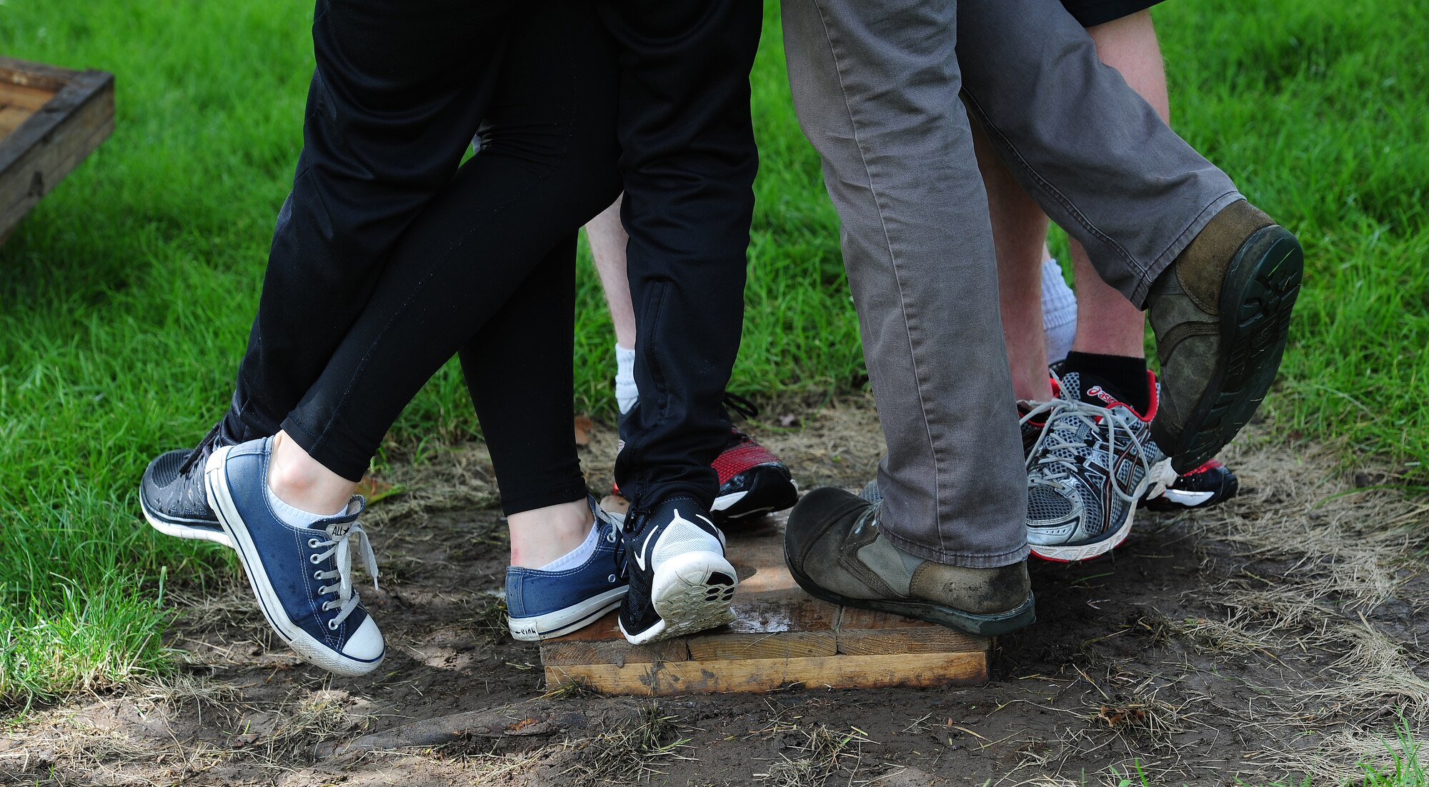 Members from Whiteman Air Force Base, Mo., balance one of the planks in the “all-aboard” challenge June 17, 2015, as part of the Tucker Leadership Lab in Liberty, Mo. Participants had to figure out how to balance one foot on the board for the duration of a song, with the size of the board significantly decreasing each time. (U.S. Air Force photo by Airman 1st Class Jazmin Smith/Released)