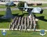 Members of the 132d Wing (132WG), Des Moines, Iowa Intelligence Surveillance Reconnaissance Group gather for a group photo in front of the static display at the 132WG on Friday, June 19, 2015.  (U.S. Air National Guard photo illustration by Tech. Sgt. Linda K. Burger/Released)(This image was manipulated using Photoshop filters and dodging and burning techniques; an individual in uniform walking in the background was erased to remove distraction from subjects being photographed; AF/ANG and Wing logos were added to the lower left and right corners, along with text on the bottom portion of the image.)