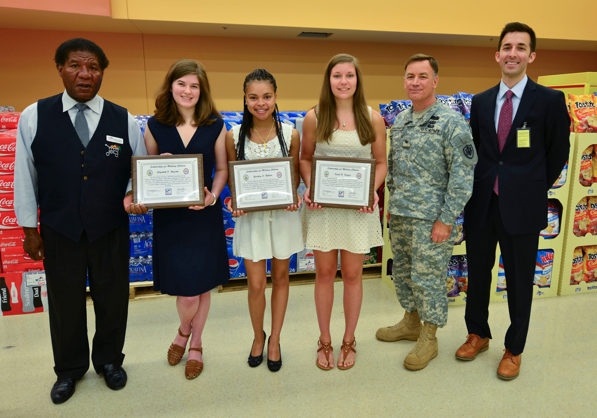 U.S. Army Col. William Galbraith, 733rd Mission Support Group commander, poses with the winners of the Scholarships for Military Children and commissary leadership during a recognition ceremony at Fort Eustis, Va., June 30, 2015.  The commissary agency and Fisher House Foundation award $2,000 scholarships annually to sons and daughters of military members. Six students were awarded the scholarship. (U.S. Air Force photo by Staff Sgt. Natasha Stannard)