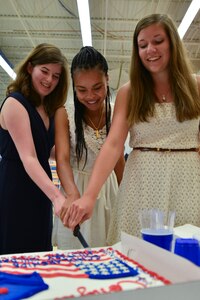 Recipients of the Scholarships for Military Children cut a celebratory cake during a recognition ceremony at Fort Eustis, Va., June 30, 2015.  Manufacturers, vendors and organizations that sell groceries or provide service to the commissaries fund the program to recognize sacrifices made by military children every day. The organization also accepts contributions at www.militaryscholar.org. (U.S. Air Force photo by Staff Sgt. Natasha Stannard)