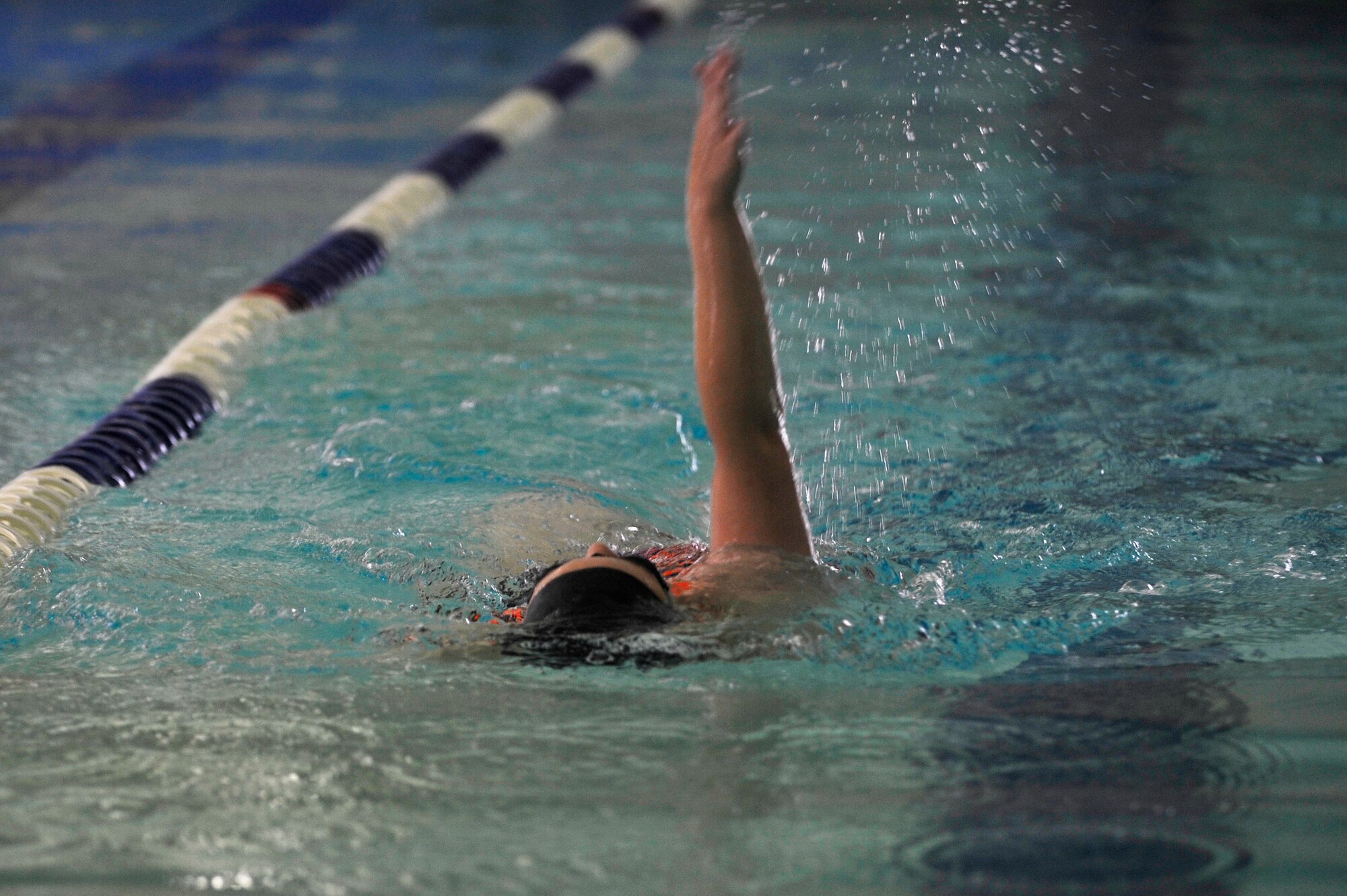 Rebecca Hill, daughter of retired U.S. Navy Chief Petty Officer Jim Hill, preforms a backstroke at the Shellbank Fitness Center indoor pool at Langley Air Force Base, Va., July 1, 2015. Service members, civilians, dependents and retirees all have access to the indoor pool. (U.S. Air Force photo by Senior Airman Breonna Veal/Released)