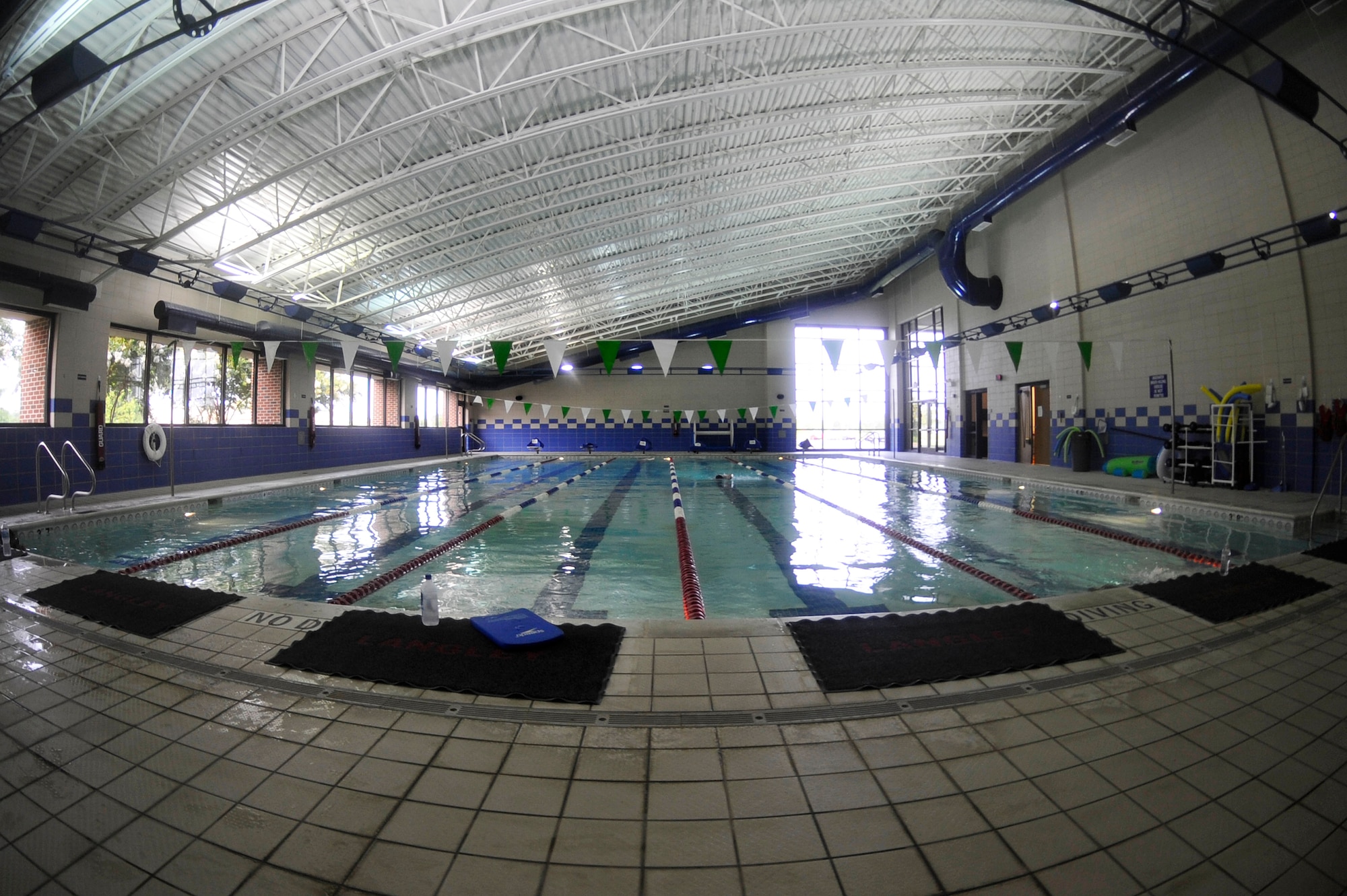 U.S. Service members swim in the Shellbank Fitness Center indoor pool at Langley Air Force Base, Va., July 1, 2015. The indoor pool is open Monday through Friday, 6 a.m. to 10 a.m., 11 a.m. to 1 p.m., and 3 p.m. to 8 p.m. (U.S. Air Force photo by Senior Airman Breonna Veal/Released) 