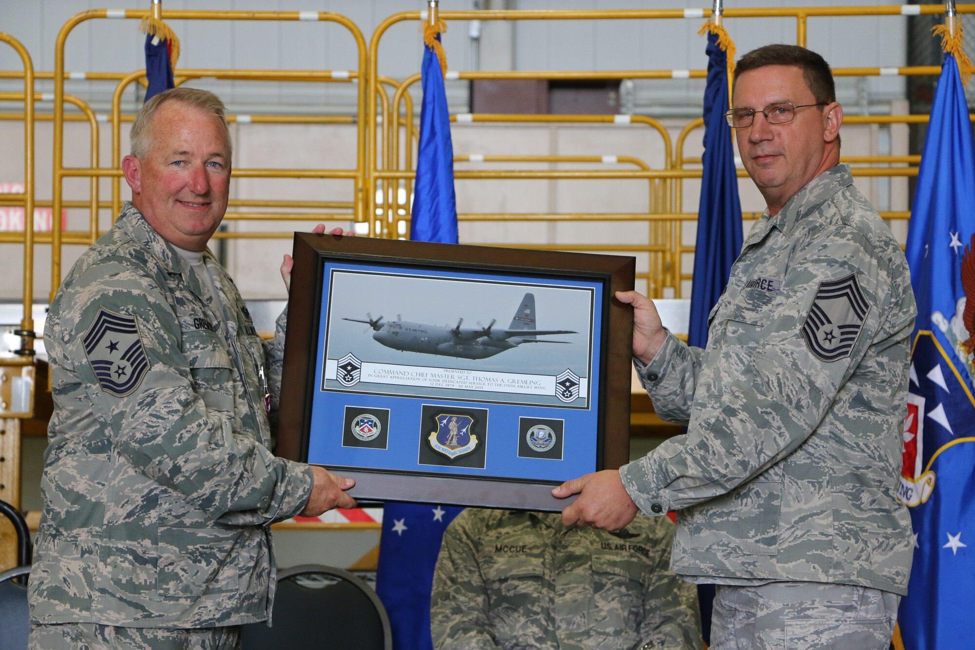 Members of the 179th Airlift Wing gather for the Command Chief Change of Command Ceremony in Mansfield, OH, May 16, 2015. Command Chief Master Sgt. Thomas A. Jones takes the position as Thomas A. Gremling retires after 35 years of service to the 179th Airlift Wing.(U.S. Air National Guard Photo by Tech. Sgt. Joe Harwood\Released)