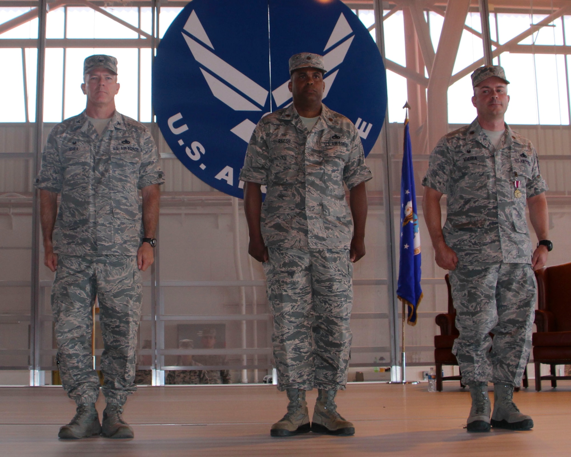 Colonel Michael Shea, 49th Maintenance Group commander, Maj. Christopher Reese, incoming 49th Maintenance Squadron commander and Maj. Anthony Vieira, outgoing 49th MXS commander stand at attention during the 49th MXS Change of Command at Holloman Air Force Base, N.M., June 30, 2015. During the ceremony, Vieira relinquished command of the 49th MXS to Reese. (U.S. Air Force photo by Airman 1st Class Emily A. Kenney/Released)   