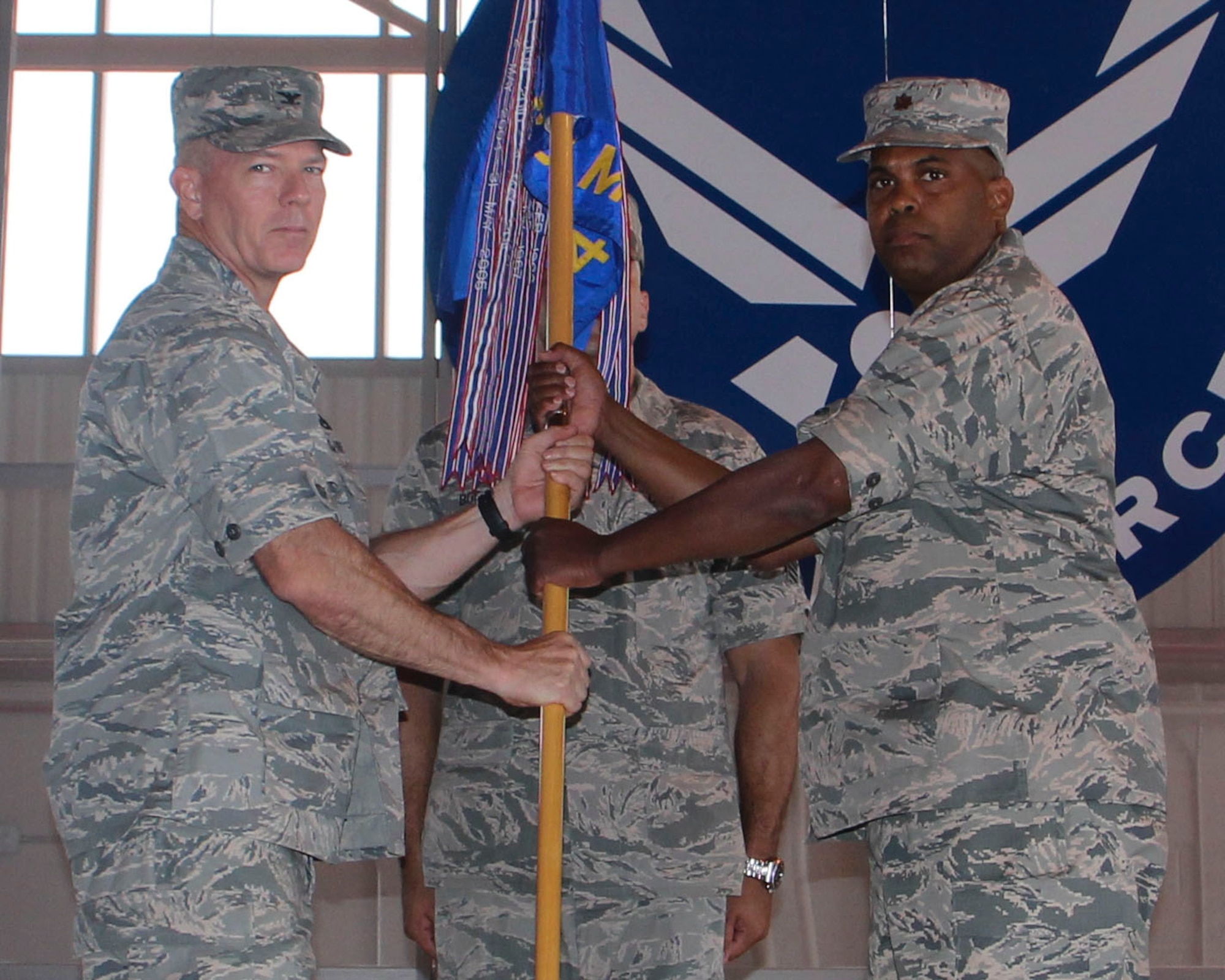 Major Christopher Reese, incoming 49th Maintenance Squadron commander, receives the 49th MXS guidon from Col. Michael Shea, 49th Maintenance Group commander, during the 49th MXS Change of Command ceremony at Holloman Air Force Base, N.M., June 30, 2015. During the ceremony, Reese accepted command of the 49th MXS from Maj. Anthony Vieira. (U.S. Air Force photo by Airman 1st Class Emily A. Kenney/Released) 