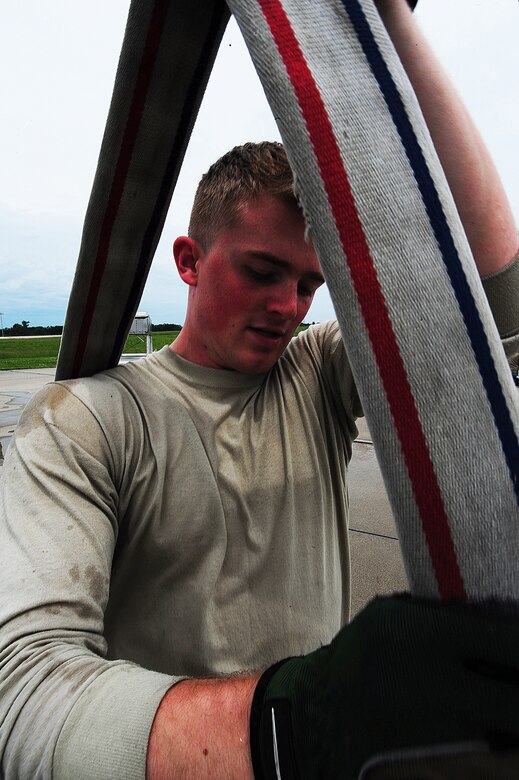 Airman 1st Class Kaleb Frazier, 509th Civil Engineer Squadron firefighter, squeezes water from a fire hose at Whiteman Air Force Base, Mo., May 28, 2015. The hose is a firefighter’s weapon to defeating raging fires that pose threats to lives, equipment and the environment. (U.S. Air Force photo by Senior Airman Keenan Berry/Released)