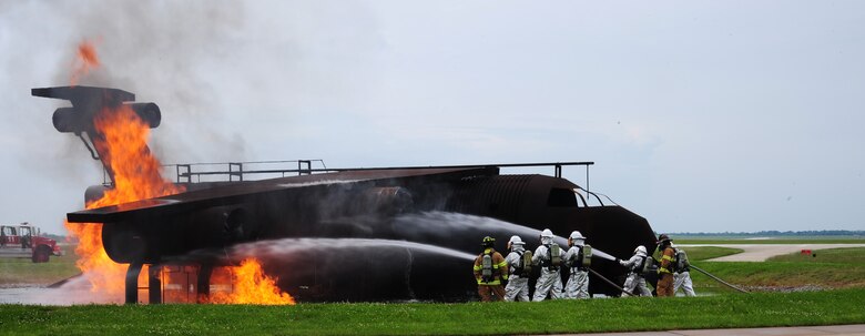 Members from the 509th Civil Engineer Squadron perform an aircraft exercise at Whiteman Air Force Base, Mo., May 28, 2015. The structural exercise ensures firefighting readiness capabilities are fine tuned. (U.S. Air Force photo by Senior Airman Keenan Berry/Released)