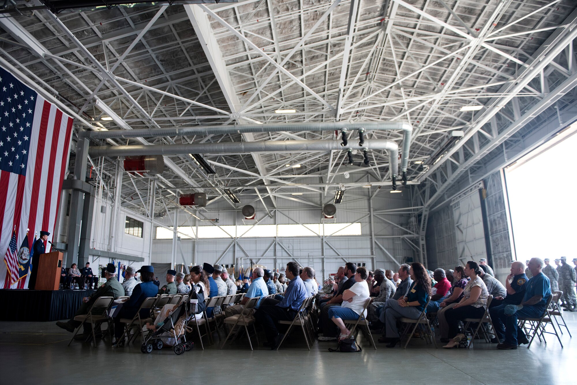 An audience of service members, community leaders and family members listens to remarks from Col. Frederick D. Thaden, Joint Base McGuire-Dix-Lakehurst and 87th Air Base Wing commander, speaks during the 87th Civil Engineer Group activation and assumption of command ceremony July 1, 2015 at JB MDL, N.J. In addition to the group activation and assumption of command portions of the ceremony, the 87th Civil Engineer Squadron was reassigned under the CEG and the 787th Civil Engineer Squadron was activated. Lt. Col. Mark R. Stevens assumed command and Linda Chominski assumed leadership of their respective squadrons.  (U.S. Air Force photo by Staff Sgt. Katherine Tereyama)
