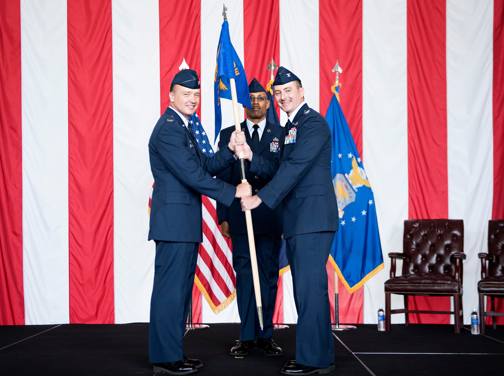 Col. Frederick D. Thaden passes the 87th Civil Engineer Group guidon to Col. Gregory McClure, as he assumes command of the newly activated unit during a ceremony July 1, 2015 at Joint Base McGuire-Dix-Lakehurst, N.J. The new structure includes a group dedicated to civil engineering and two subordinate squadrons responsible for facility and installation management and maintenance; explosives ordnance disposal; fire protection; readiness support; emergency response and operations; and more. (U.S. Air Force photo by Staff Sgt. Katherine Tereyama)
